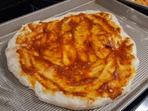 pizza dough with sauce